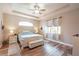 Inviting main bedroom with tray ceilings, wood floors, and neutral décor at 5480 White Ibis Dr, North Port, FL 34287