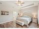 Comfortable main bedroom with wood floors, neutral colors, and lots of natural light at 5480 White Ibis Dr, North Port, FL 34287