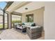 Relaxing screened-in patio with comfortable seating, a coffee table, and a peaceful view of the outdoors at 5480 White Ibis Dr, North Port, FL 34287