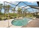 An inviting pool with a screened enclosure, complemented by lush landscaping and a serene view at 5480 White Ibis Dr, North Port, FL 34287