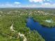 Aerial view showcasing the lake and lush green surroundings, offering a serene escape at 5623 Palm Aire Dr, Sarasota, FL 34243