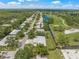 An aerial view of the property with the golf course running alongside the homes at 5623 Palm Aire Dr, Sarasota, FL 34243