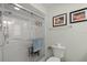 Clean bathroom features tiled shower with a glass door and safety bar, and comfort height toilet at 5623 Palm Aire Dr, Sarasota, FL 34243