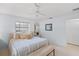 Bright bedroom with bed and bench seating, mirror, fan, and carpeting at 5623 Palm Aire Dr, Sarasota, FL 34243