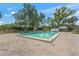 Community swimming pool with a paved sunbathing area and a clear blue swimming pool at 5623 Palm Aire Dr, Sarasota, FL 34243