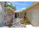 Private brick courtyard with well-maintained landscaping and seating, with access to the house at 5623 Palm Aire Dr, Sarasota, FL 34243