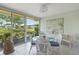 Bright dining area featuring a glass table with wicker chairs and great outdoor views at 5623 Palm Aire Dr, Sarasota, FL 34243