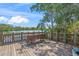 Wooden dock offers a serene space with a bench, bicycle, and beautiful lakeside views at 5623 Palm Aire Dr, Sarasota, FL 34243
