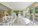 Florida room with comfortable seating, neutral decor, and views of the golf course at 5623 Palm Aire Dr, Sarasota, FL 34243