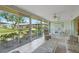 Inviting sunroom with comfortable furniture and large windows offering backyard views at 5623 Palm Aire Dr, Sarasota, FL 34243