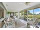 Relaxing Florida room features neutral decor, tile floor, and expansive views of the golf course at 5623 Palm Aire Dr, Sarasota, FL 34243