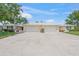 A lovely home with a two-car garage and manicured landscaping flanking a wide driveway at 5623 Palm Aire Dr, Sarasota, FL 34243