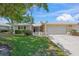 Charming single-story home with a well-manicured lawn and attached two-car garage at 5623 Palm Aire Dr, Sarasota, FL 34243