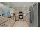 Bright kitchen features stainless steel appliances, granite countertops, and ample cabinet space at 5623 Palm Aire Dr, Sarasota, FL 34243