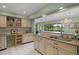 Spacious kitchen with granite counters and cabinets, plus views to the bright breakfast area at 5623 Palm Aire Dr, Sarasota, FL 34243