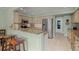 Well-equipped kitchen features granite countertops, stainless steel appliances, and breakfast bar seating at 5623 Palm Aire Dr, Sarasota, FL 34243