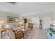 Comfortable living room featuring tiled floors, a plush sofa, and a view of the outside scenery at 5623 Palm Aire Dr, Sarasota, FL 34243