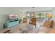 Bright living room with tile flooring, comfortable seating, and view to the patio at 5623 Palm Aire Dr, Sarasota, FL 34243