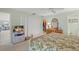 Comfortable main bedroom with en suite bathroom and large closet, television and ceiling fan at 5623 Palm Aire Dr, Sarasota, FL 34243