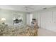 Bright main bedroom with attached office space, and large closet, with ceiling fan and neutral carpeting at 5623 Palm Aire Dr, Sarasota, FL 34243