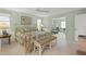 Bright, spacious main bedroom features en-suite bathroom and sitting area, with a ceiling fan and neutral carpeting at 5623 Palm Aire Dr, Sarasota, FL 34243