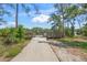 Concrete path leads to a wooden observation point with a scenic view of the lake and surrounding nature at 5623 Palm Aire Dr, Sarasota, FL 34243