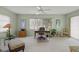 Well-lit office features a large window, ceiling fan, and comfortable seating for a productive work environment at 5623 Palm Aire Dr, Sarasota, FL 34243