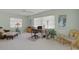 Well-lit office features large windows, ceiling fan, and comfortable seating, offering a tranquil workspace at 5623 Palm Aire Dr, Sarasota, FL 34243