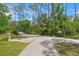 Scenic park pathway featuring a wooden bridge surrounded by lush greenery, creating a serene outdoor escape at 5623 Palm Aire Dr, Sarasota, FL 34243