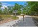 Picturesque walking path with signage, offering directions and information within a community park setting at 5623 Palm Aire Dr, Sarasota, FL 34243