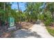 Scenic pathway surrounded by trees and lush foliage, providing a peaceful area for walking and relaxation at 5623 Palm Aire Dr, Sarasota, FL 34243