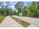 A quiet neighborhood street featuring a pedestrian and bike crossing for a safe and enjoyable community at 5623 Palm Aire Dr, Sarasota, FL 34243