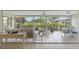 Bright sunroom featuring tiled floors, comfortable seating and panoramic views of lush landscaping at 5623 Palm Aire Dr, Sarasota, FL 34243