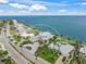 Aerial view showcasing the house with it's well kept lawn and waterfront location at 619 Key Royale Dr, Holmes Beach, FL 34217