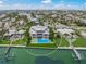 Aerial view showcasing the house with it's well kept lawn and waterfront location at 619 Key Royale Dr, Holmes Beach, FL 34217