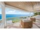 Inviting covered balcony with seating and panoramic views of the bay and waterfront at 619 Key Royale Dr, Holmes Beach, FL 34217