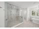 Luxurious bathroom boasts a marble shower, soaking tub, and elegant finishes at 619 Key Royale Dr, Holmes Beach, FL 34217