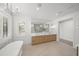 Bright and spacious bathroom featuring dual sinks, soaking tub, and a large walk-in shower at 619 Key Royale Dr, Holmes Beach, FL 34217
