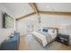 Charming bedroom with wood beam ceilings, white walls, and a cozy, light blue accent rug at 619 Key Royale Dr, Holmes Beach, FL 34217