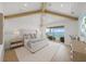 Bright primary bedroom featuring vaulted ceilings, light hardwood floors, and access to private balcony at 619 Key Royale Dr, Holmes Beach, FL 34217