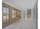 Inviting entryway featuring marble floors, elegant doors, and a staircase at 619 Key Royale Dr, Holmes Beach, FL 34217