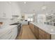 Modern kitchen featuring white cabinetry, stainless steel appliances, and a large island at 619 Key Royale Dr, Holmes Beach, FL 34217