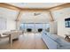 Bright and airy living room with wood beams, large windows with ocean views, and modern furnishings at 619 Key Royale Dr, Holmes Beach, FL 34217