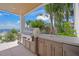 Well-appointed outdoor kitchen with stainless steel grill, sink, and cabinets overlooking lush landscaping at 619 Key Royale Dr, Holmes Beach, FL 34217