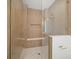 Modern tiled shower with glass doors, a built-in bench, and spa-like fixtures at 619 Key Royale Dr, Holmes Beach, FL 34217