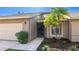Inviting front entry showcasing a well-kept lawn, a two-car garage and beautiful exterior lighting at 620 49Th E St, Bradenton, FL 34208