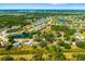 Aerial view showcasing the neighborhood's lush green landscape, several tranquil ponds, and homes in the distance at 7158 S Leewynn Dr, Sarasota, FL 34240