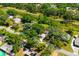 An aerial displays properties bordering a canal and lush greenery, set in a serene residential area at 7158 S Leewynn Dr, Sarasota, FL 34240