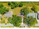 A serene aerial view of a home, showcasing its lush surroundings and convenient access to a nearby stream at 7158 S Leewynn Dr, Sarasota, FL 34240