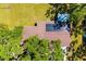 Aerial view showcasing the home's roof with solar panels, lush greenery, and adjacent shed at 7158 S Leewynn Dr, Sarasota, FL 34240